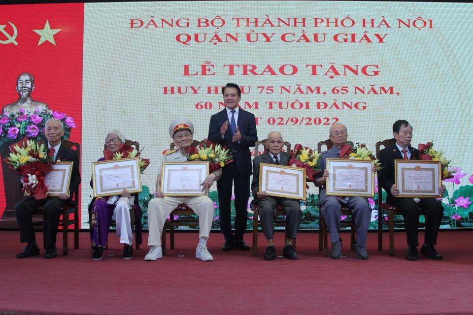 Chủ nhiệm Ủy ban Kiểm tra Thành ủy Hà Nội Hoàng Trọng Quyết trao Huy hiệu 75 năm tuổi Đảng cho các đảng viên.